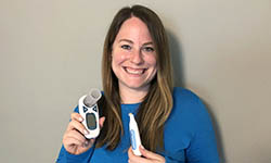 Jennifer Dahne holds smartphone-enabled devices used in remote clinical trials